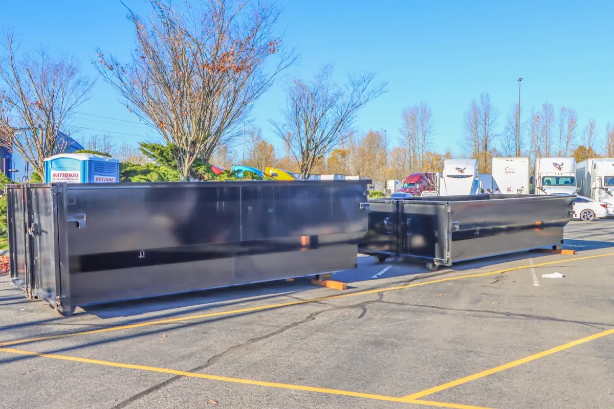 Professional dumpster rental service with roll-off container on residential driveway in Meridian